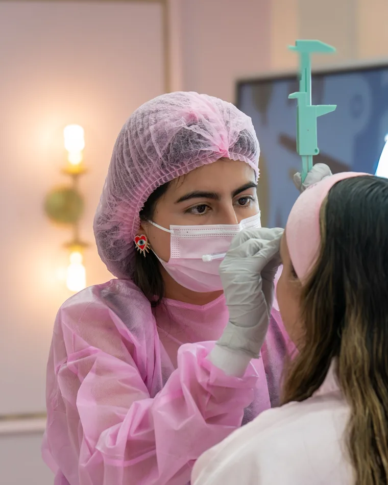 A student in full PPE working on a live model