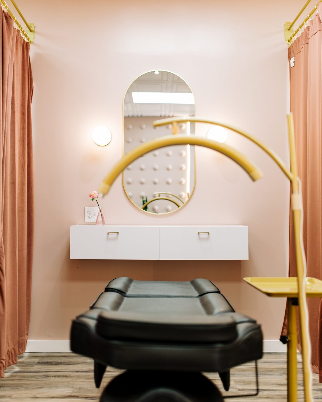 A single permanent makeup station in Salem, NH with procedure bed, arc lamp and mirror