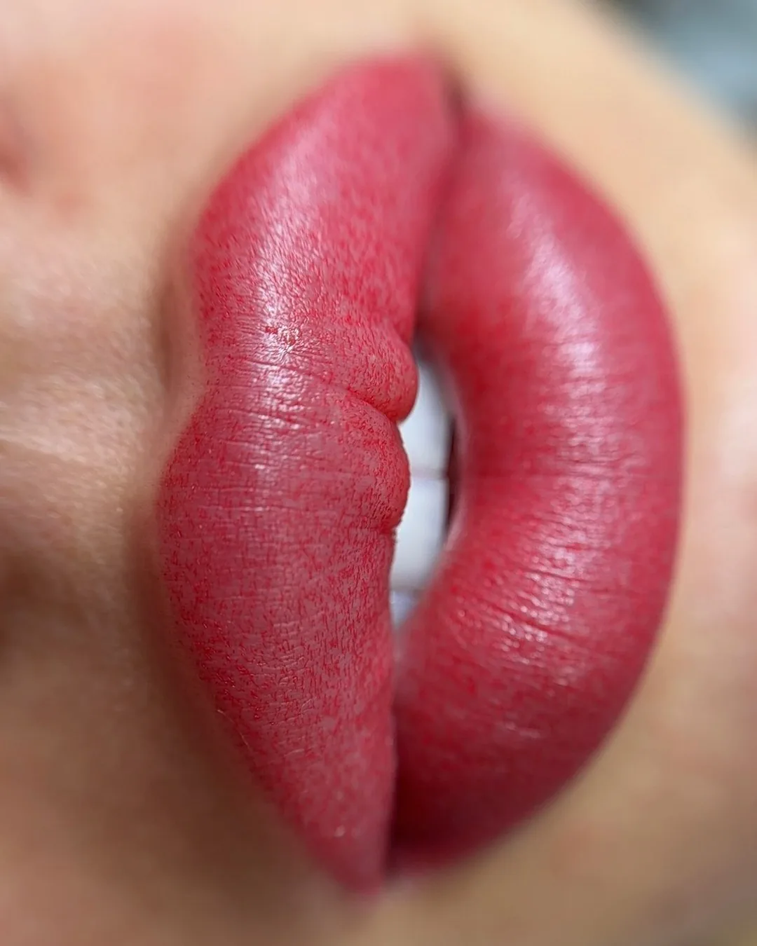 Healed lip blush in a bright warm tone with visible natural lip texture through the colour