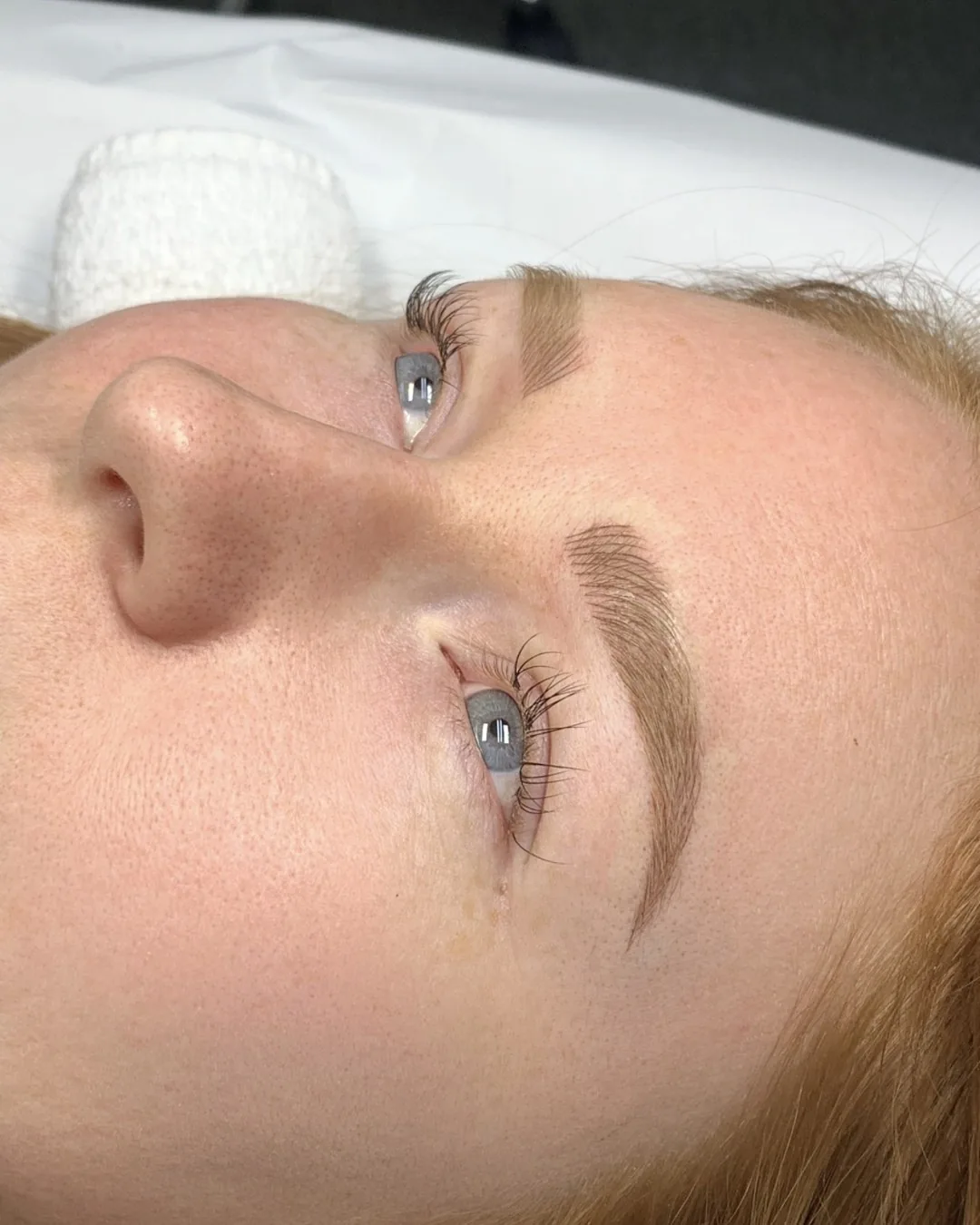 Healed microblading brow in profile with a defined tail and a softer, lighter front