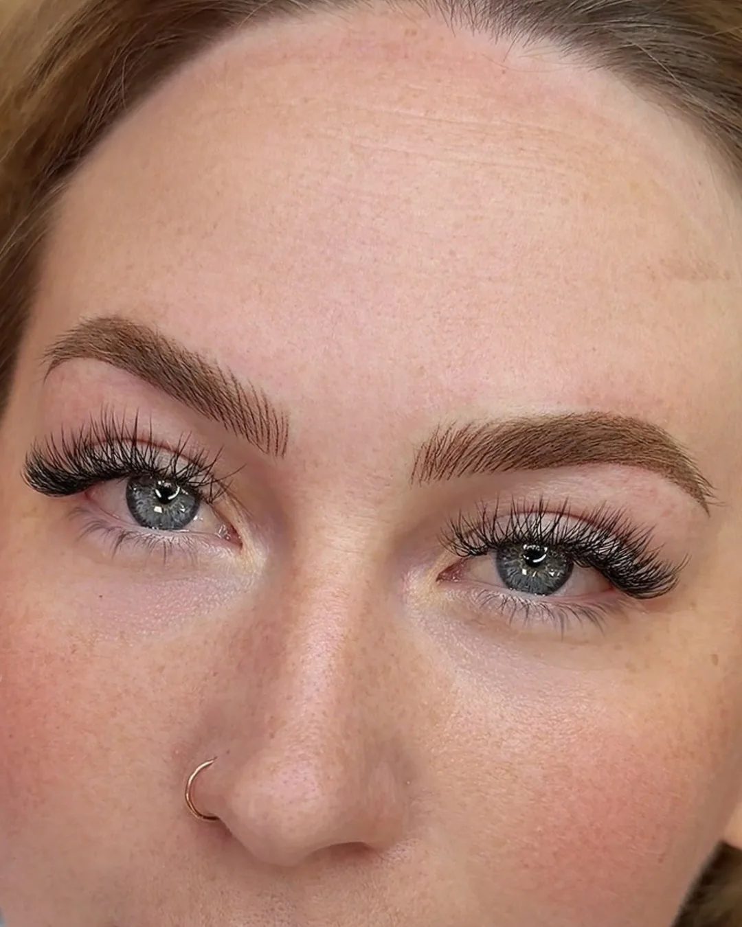 Nano combo healed: strokes sitting over a light shaded base. Healed nano combo brows seen straight on, with visible strokes over a light shaded base